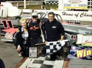 Aric Iosue in Oswego Speedway Victory Lane with parents Gail and Dave.