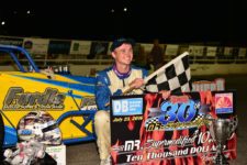 David Danzer poses in Oswego Speedway victory lane after winning his second Mr. Supermodified