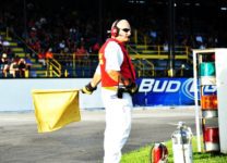 Oswego Speedway corner flagman displays the Canale Insurance caution flag