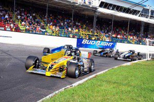 Supermodified veteran Jerry Curran (24) leads a group of drivers into Oswego Speedway's first turn during the 2015 International Classic 200. (Bill Taylor)